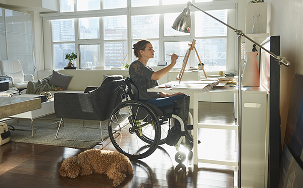 CC Lifestyle Caucasian woman in wheelchair painting on easel