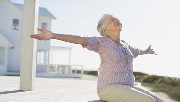 image woman with arms outstretched in the sunshine, the importance of keeping healthy skin healthy